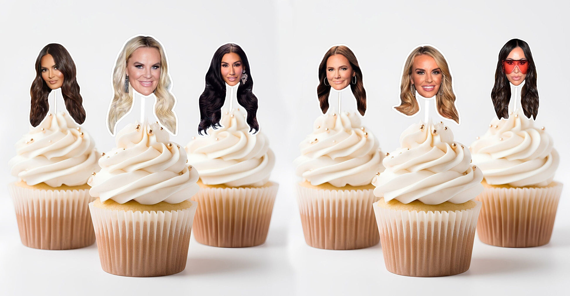 May include: Six cupcakes with white frosting and edible images of women on top. The images are printed on paper and attached to toothpicks. The cupcakes are arranged in two rows of three.